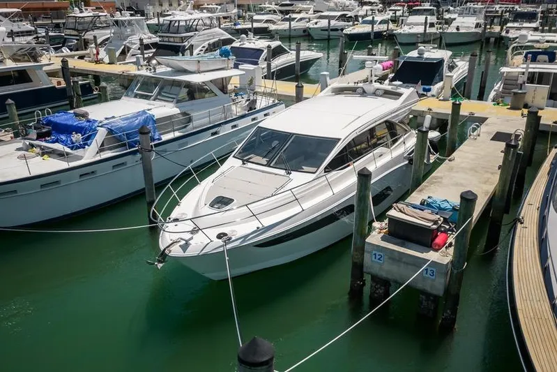  Yacht Photos Pics 2017 Sea Ray Sundancer 460 yacht docked in a busy marina.
