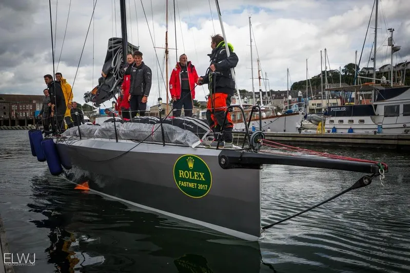 Maverick Yacht Photos Pics Sailing crew on Infiniti 46 yacht at Rolex Fastnet 2017, docked in a marina.