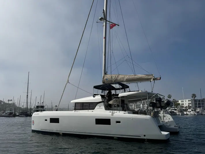 Catalina Breeze Yacht Photos Pics 2022 Lagoon 42 catamaran docked in a marina, featuring sleek design and modern sails.