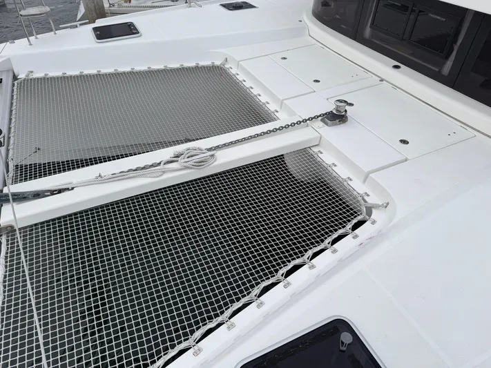 Catalina Breeze Yacht Photos Pics 2022 Lagoon 42 catamaran deck with netting and anchor chain.