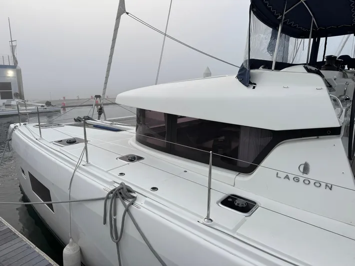 Catalina Breeze Yacht Photos Pics 2022 Lagoon 42 catamaran docked at a marina on a foggy day.