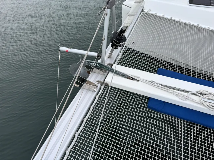 Catalina Breeze Yacht Photos Pics Catamaran deck with netting, Lagoon 42, 2022 model, on calm water.