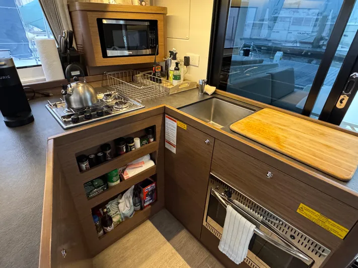 Catalina Breeze Yacht Photos Pics Modern kitchen in 2022 Lagoon 42 yacht with stove, microwave, and sink.