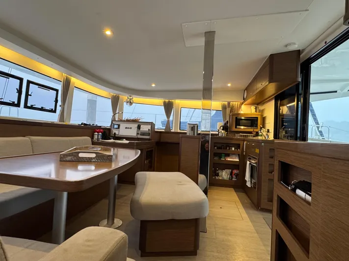 Catalina Breeze Yacht Photos Pics Interior of 2022 Lagoon 42 catamaran, featuring modern kitchen and dining area with ample seating.