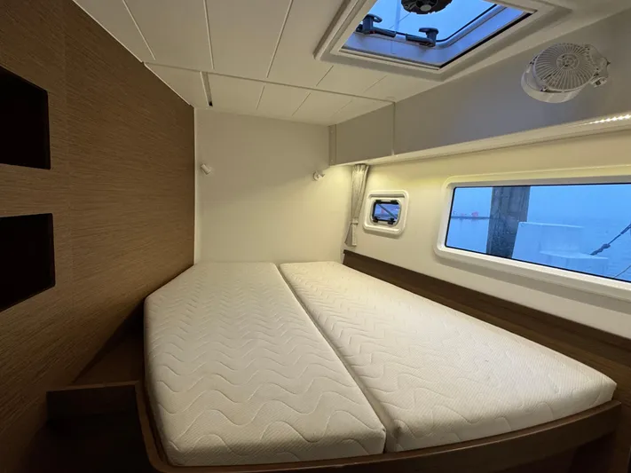 Catalina Breeze Yacht Photos Pics Interior cabin of 2022 Lagoon 42 catamaran with bed, window, and ceiling hatch.
