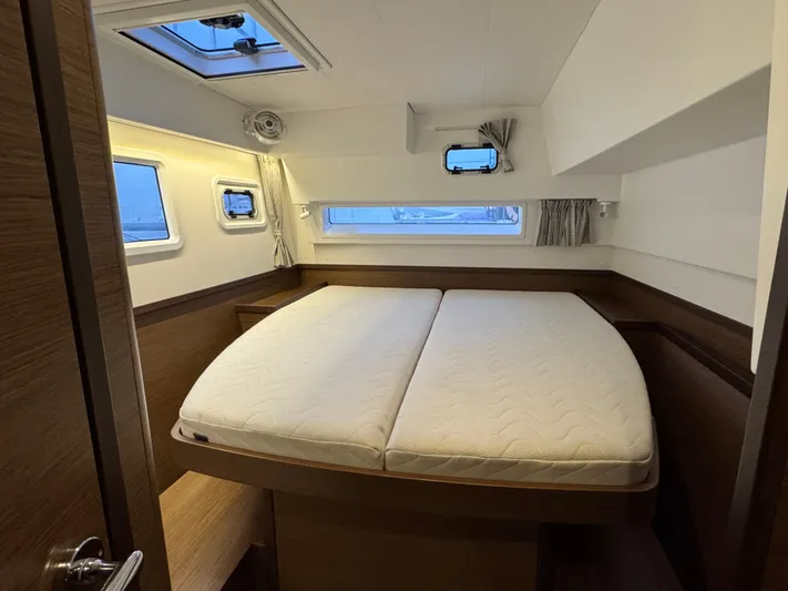 Catalina Breeze Yacht Photos Pics Luxurious cabin interior of 2022 Lagoon 42 catamaran with large bed and windows.