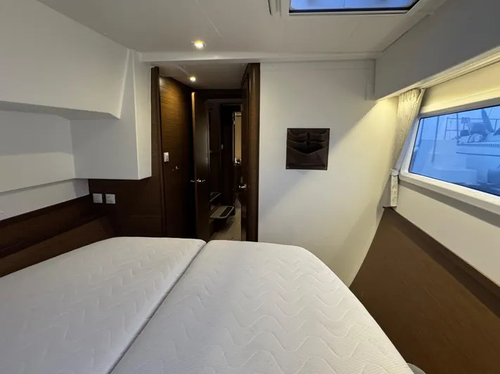Catalina Breeze Yacht Photos Pics Luxurious interior cabin of 2022 Lagoon 42 catamaran with modern design and cozy bedding.