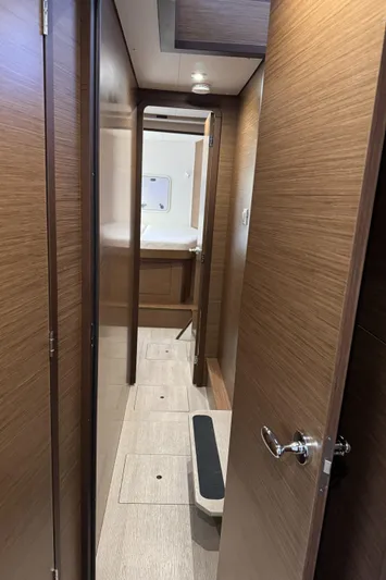 Catalina Breeze Yacht Photos Pics Interior hallway of 2022 Lagoon 42 yacht, featuring wooden doors and modern design.