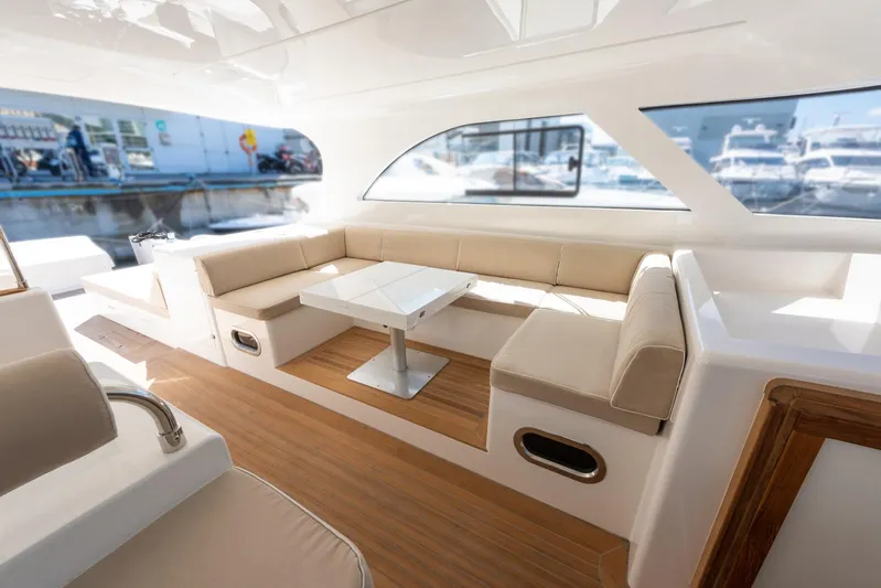 51 Fly Yacht Photos Pics Luxurious interior of 2025 Toy 51 Fly yacht with elegant seating and table.