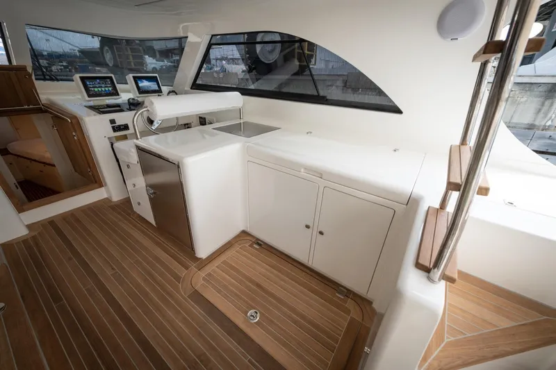 51 Fly Yacht Photos Pics Luxurious interior of 2025 Toy 51 Fly yacht with modern navigation equipment and wooden flooring.
