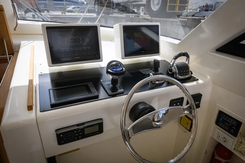 51 Fly Yacht Photos Pics Control panel of 2025 Toy 51 Fly yacht with dual screens and steering wheel.