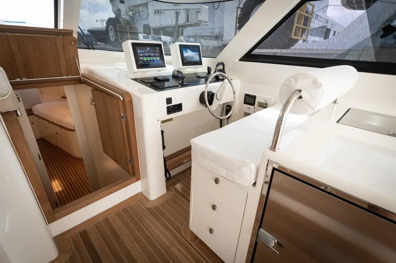 51 Fly Yacht Photos Pics 2025 Toy 51 Fly yacht interior with modern navigation equipment and wooden accents.