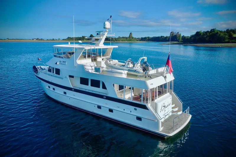 Bravo! Yacht Photos Pics 2012 Outer Reef Yachts 700 Motoryacht cruising on calm blue waters.