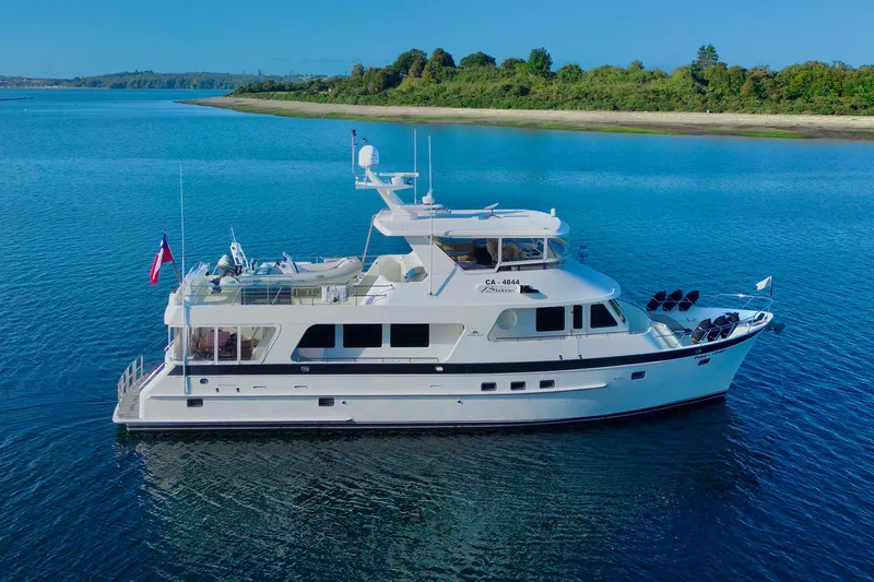 Bravo! Yacht Photos Pics 2012 Outer Reef Yachts 700 Motoryacht cruising on calm blue waters.