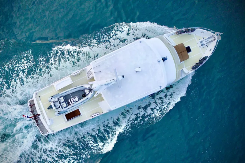 Bravo! Yacht Photos Pics Aerial view of 2012 Outer Reef Yachts 700 Motoryacht cruising on blue water.