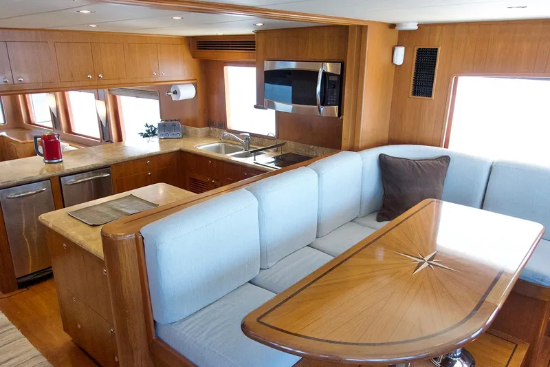 Bravo! Yacht Photos Pics Luxurious interior of 2012 Outer Reef Yachts 700 Motoryacht with modern kitchen and dining area.