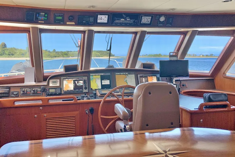 Bravo! Yacht Photos Pics Pilothouse of 2012 Outer Reef Yachts 700 Motoryacht with navigation equipment and panoramic windows.