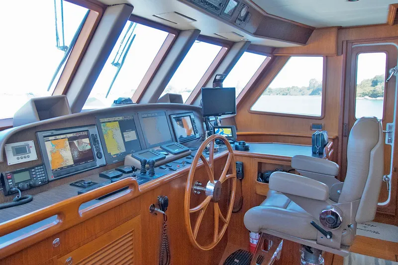 Bravo! Yacht Photos Pics Pilothouse of 2012 Outer Reef Yachts 700 Motoryacht with navigation equipment and captain's chair.