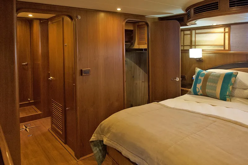 Bravo! Yacht Photos Pics Luxurious cabin interior of 2012 Outer Reef Yachts 700 Motoryacht with wooden finishes.