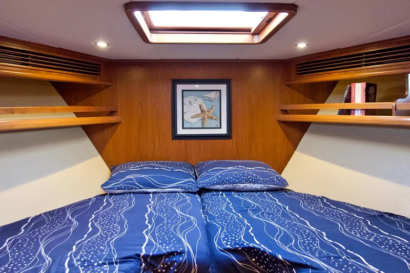 Bravo! Yacht Photos Pics Cozy bedroom in 2012 Outer Reef Yachts 700 Motoryacht with nautical decor and skylight.