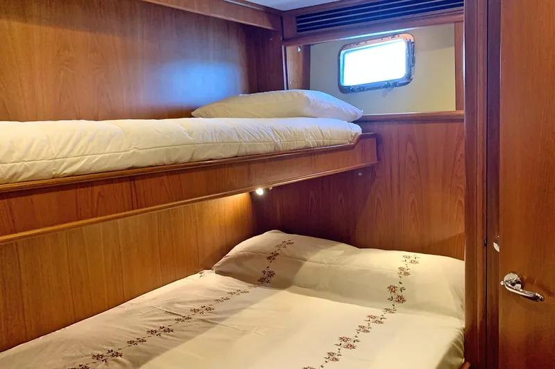 Bravo! Yacht Photos Pics Bunk beds in 2012 Outer Reef Yachts 700 Motoryacht cabin with wooden interior.