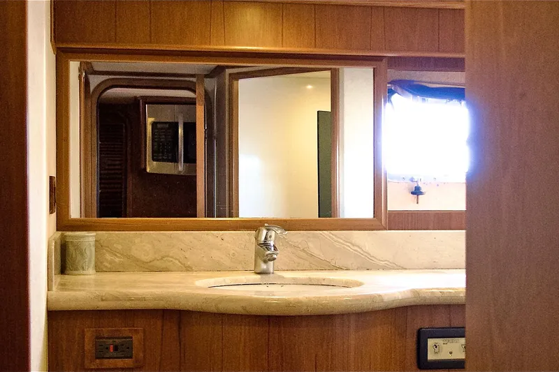 Bravo! Yacht Photos Pics Luxurious bathroom interior of 2012 Outer Reef Yachts 700 Motoryacht with marble countertop.