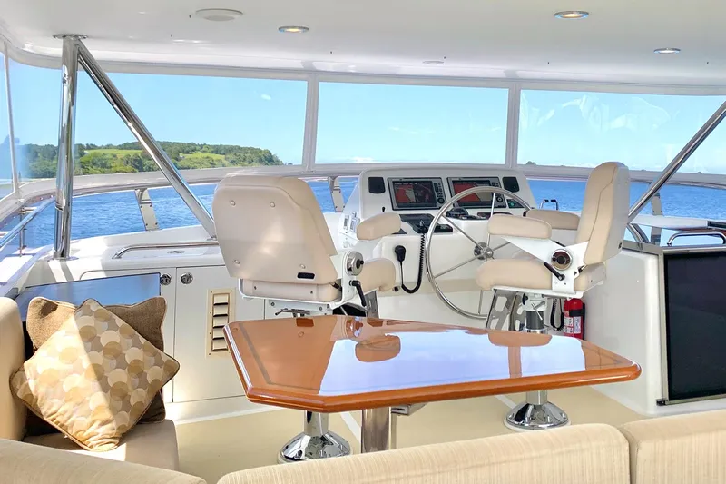 Bravo! Yacht Photos Pics Luxurious 2012 Outer Reef Yachts 700 Motoryacht helm with plush seating and scenic views.