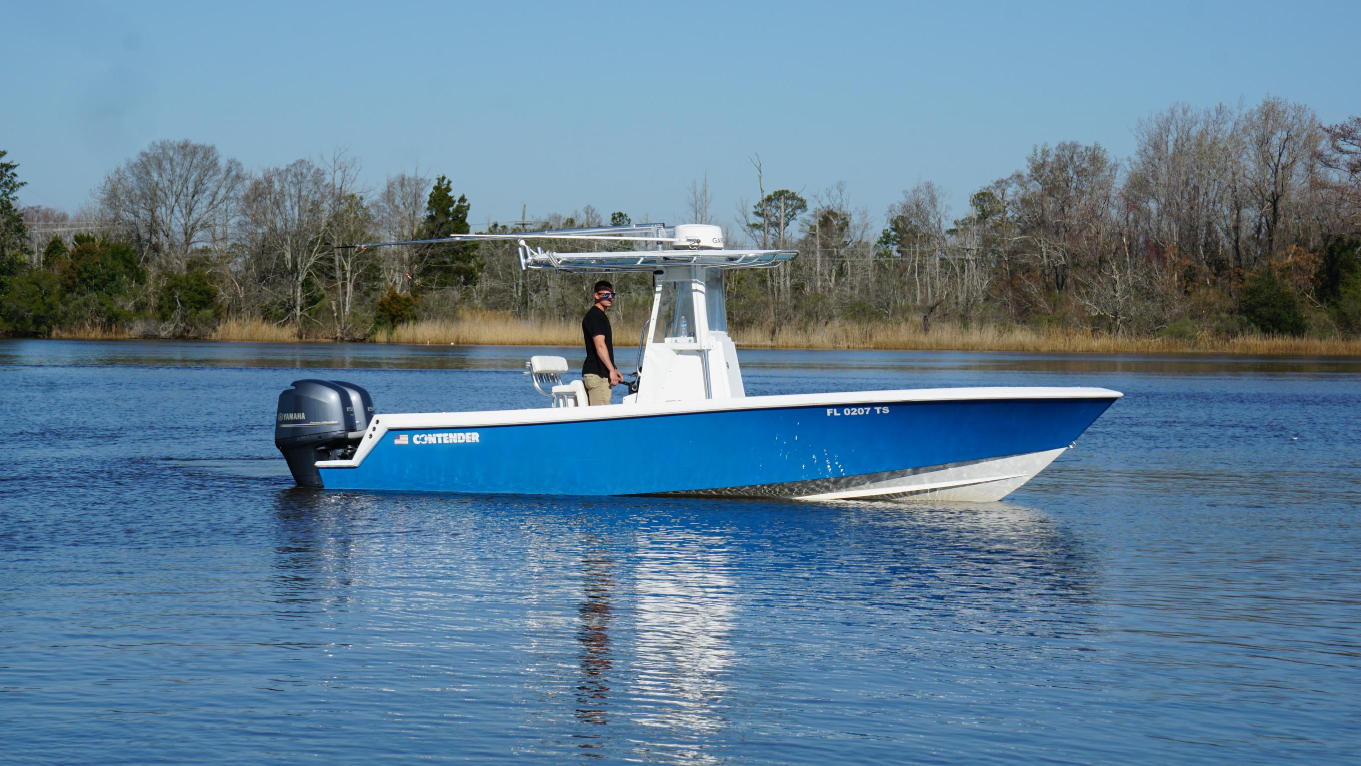 2015 Contender 25 Tournament boat on calm water, side view.