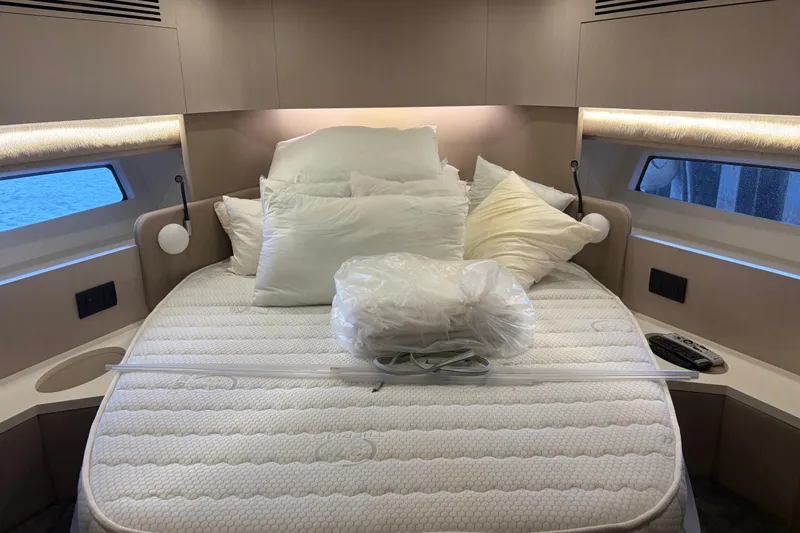 Fire Sale! Yacht Photos Pics Luxurious Azimut 55 yacht bedroom interior, 2020 model, featuring a cozy bed with pillows.