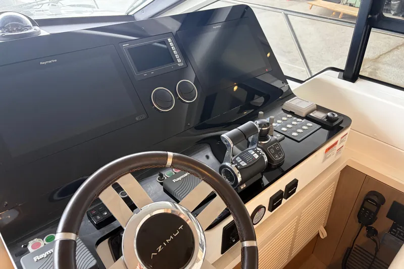 Fire Sale! Yacht Photos Pics Cockpit of 2020 Azimut 55 yacht with advanced navigation controls and steering wheel.