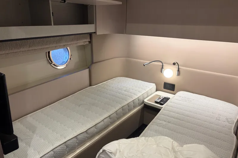 Fire Sale! Yacht Photos Pics Twin cabin in 2020 Azimut 55 yacht with modern decor and porthole window.