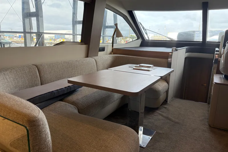 Fire Sale! Yacht Photos Pics Luxurious interior of 2020 Azimut 55 yacht with elegant seating and table.