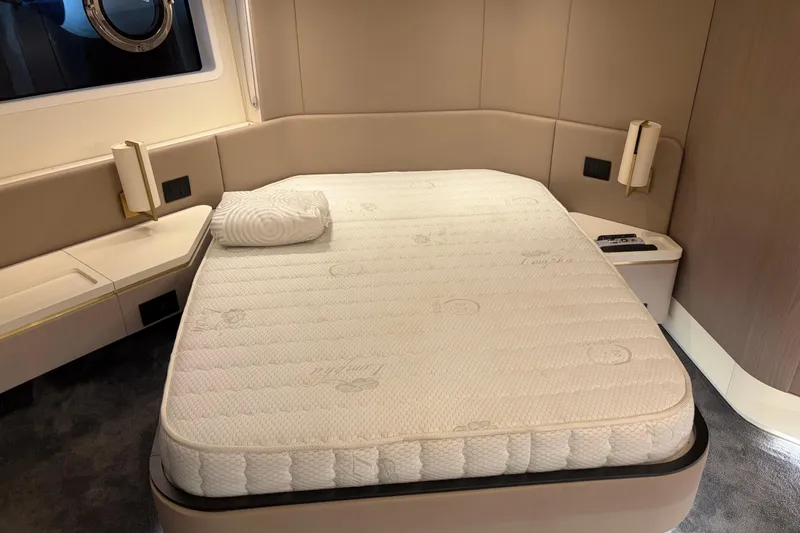 Fire Sale! Yacht Photos Pics Luxurious bedroom interior of 2020 Azimut 55 yacht with plush mattress and modern design.