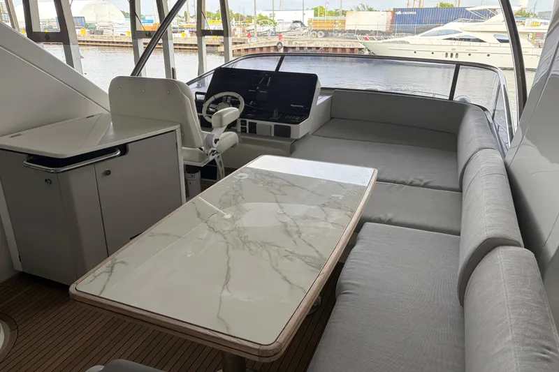 Fire Sale! Yacht Photos Pics Luxurious 2020 Azimut 55 yacht interior with marble table and plush seating.