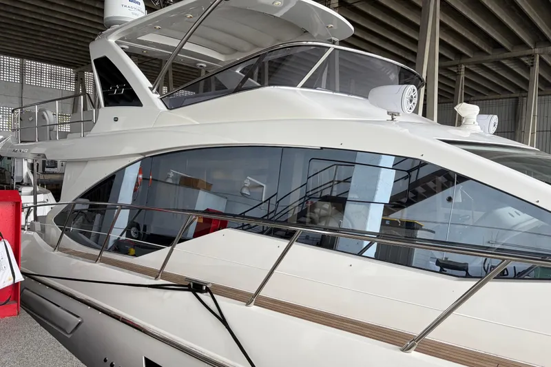 Fire Sale! Yacht Photos Pics 2020 Azimut 55 yacht in a marina, showcasing sleek design and modern features.