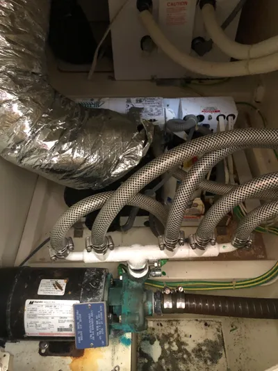 Coastal Pioneer Yacht Photos Pics Engine room of 2002 Fairline Phantom 50 with hoses and machinery.