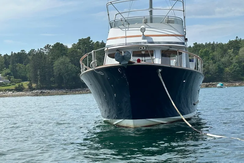  Yacht Photos Pics 1987 Albin North Sea Trawler anchored in scenic waters with forested shoreline.