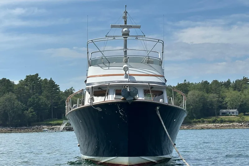 Yacht Photos Pics 1987 Albin North Sea Trawler anchored in scenic waters with forested shoreline.