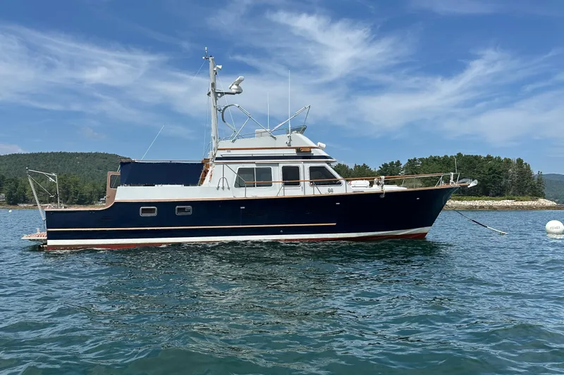  Yacht Photos Pics 1987 Albin North Sea Trawler on calm water, scenic background, clear sky.