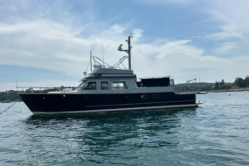  Yacht Photos Pics 1987 Albin North Sea Trawler on calm water under a partly cloudy sky.