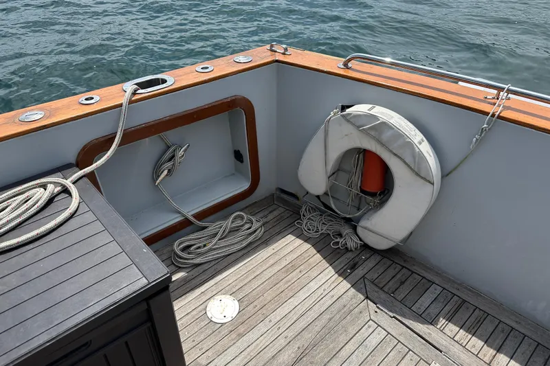  Yacht Photos Pics 1987 Albin North Sea Trawler deck with ropes and life preserver by the water.