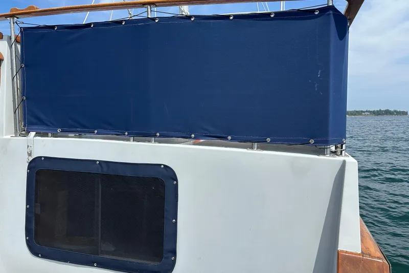  Yacht Photos Pics 1987 Albin North Sea Trawler with blue canvas cover on deck, ocean in background.