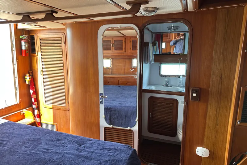  Yacht Photos Pics Interior of 1987 Albin North Sea Trawler with wood paneling and compact bathroom.