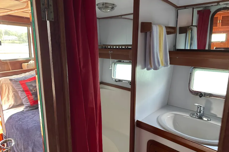  Yacht Photos Pics 1987 Albin North Sea Trawler interior with cozy bedroom and compact bathroom.
