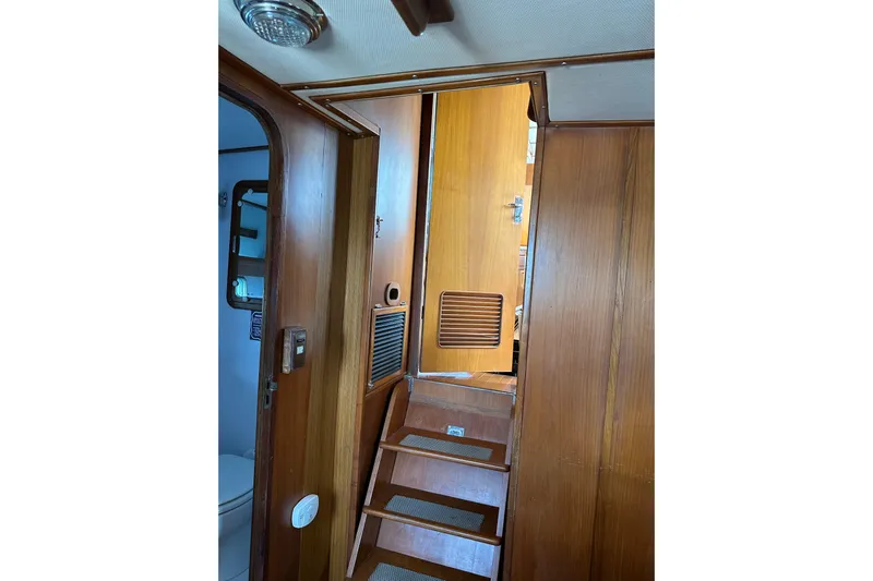  Yacht Photos Pics Interior of 1987 Albin North Sea Trawler with wooden stairs and door.