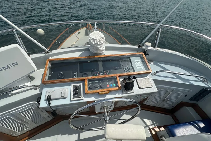 Yacht Photos Pics 1987 Albin North Sea Trawler helm with navigation equipment and steering wheel on open water.