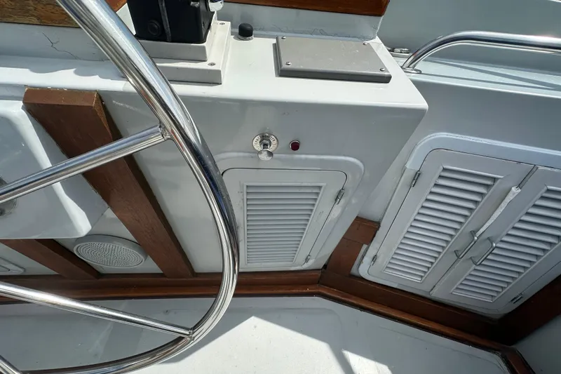  Yacht Photos Pics Helm area of 1987 Albin North Sea Trawler with steering wheel and control panel.