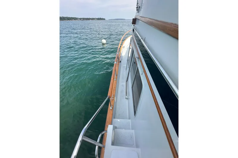 Yacht Photos Pics 1987 Albin North Sea Trawler on calm water, showcasing deck and railing.