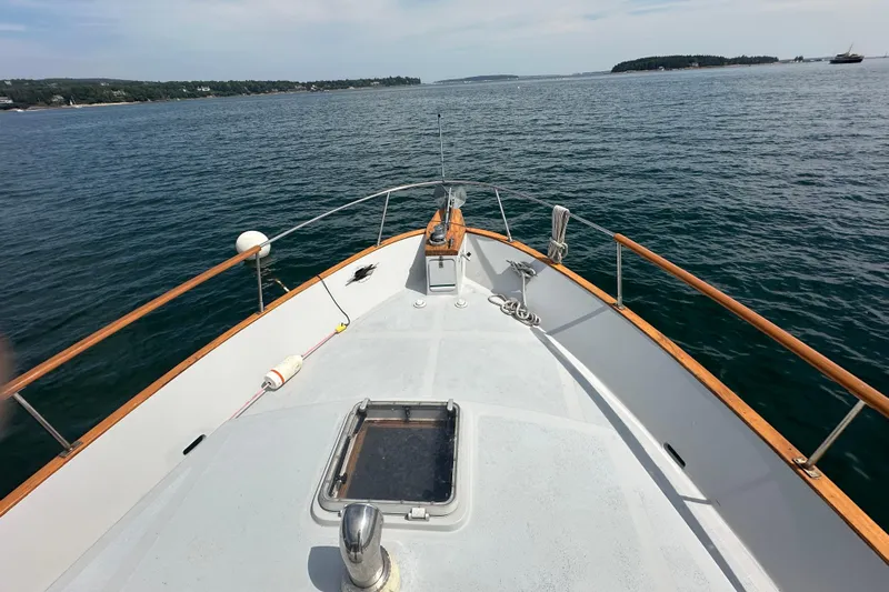  Yacht Photos Pics 1987 Albin North Sea Trawler cruising on calm waters, scenic coastal view.