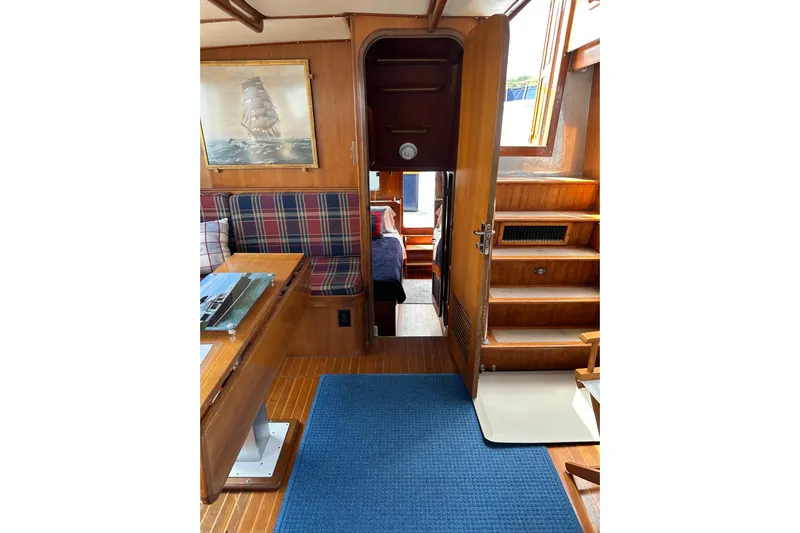  Yacht Photos Pics 1987 Albin North Sea Trawler interior with wood paneling, plaid seating, and nautical decor.